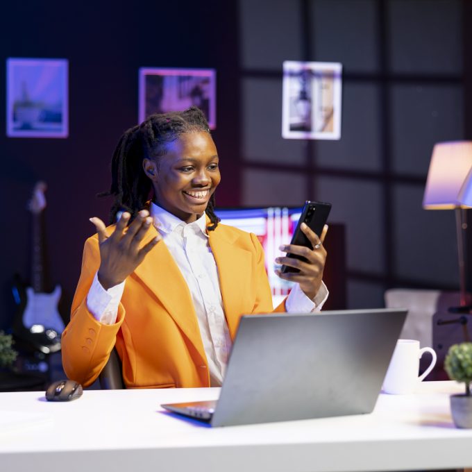 Happy woman relaxing in apartment, texting friends on cellphone